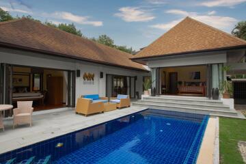 Luxurious outdoor swimming pool with adjacent open living spaces in a modern villa