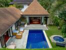 Aerial view of a luxurious property with a swimming pool and lush garden