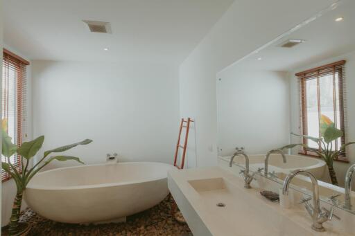 Spacious modern bathroom with freestanding tub and dual sinks