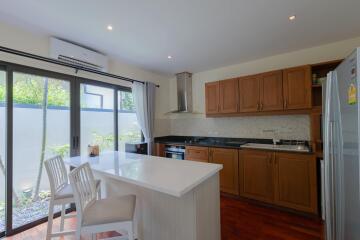 Modern kitchen with wooden cabinets and central island