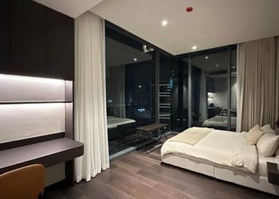 Modern bedroom interior with a view of the cityscape at night