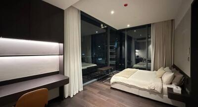 Modern bedroom interior with a view of the cityscape at night