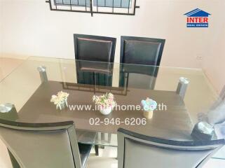 Modern dining area with glass table and black chairs