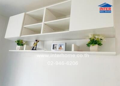 Modern white living room shelves with decorative items and books