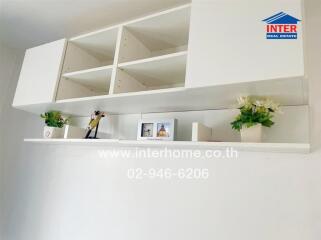 Modern white living room shelves with decorative items and books
