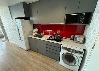 Modern kitchen with integrated appliances and red backsplash