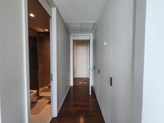 Spacious and modern hallway with wooden flooring leading to various rooms