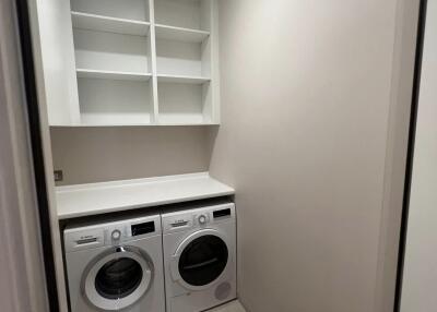 Modern laundry room with built-in appliances