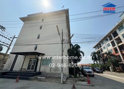 Exterior view of a modern multi-story residential building with a clear sky