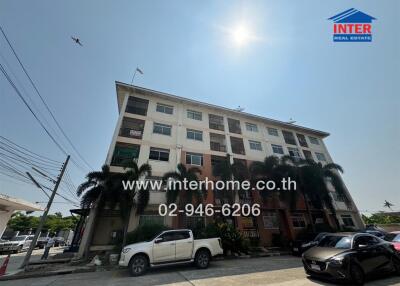 Exterior view of a multi-story residential building with clear blue sky