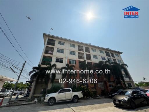 Exterior view of a multi-story residential building with clear blue sky