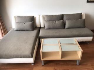 Modern living room with sectional sofa and wooden coffee table