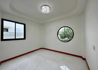 Spacious empty bedroom with circular and rectangular windows