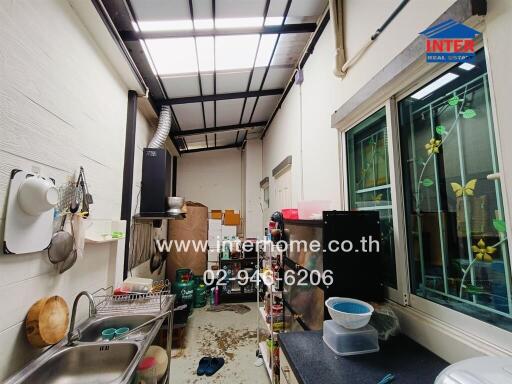 Compact commercial kitchen space with storage and equipment