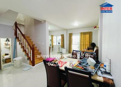 Spacious and well-lit living room with staircase and study area