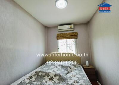 Compact bedroom with natural light and air conditioning