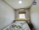 Compact bedroom with natural light and air conditioning