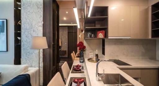 Modern kitchen with integrated dining area, featuring marble countertops and stylish cabinetry