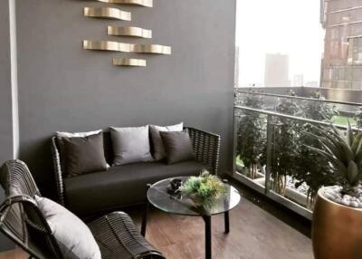 Modern balcony with cozy seating and decorative plants