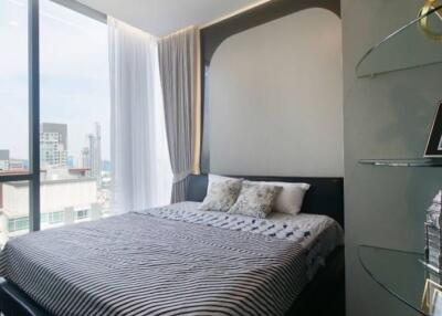 Modern bedroom with large window and city view