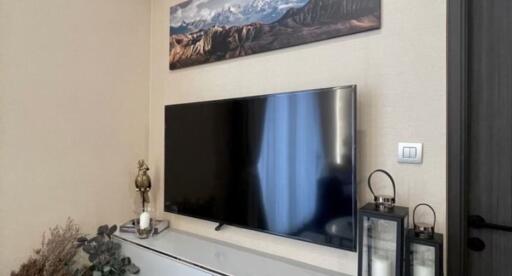 Modern living room with wall-mounted TV and decorative items