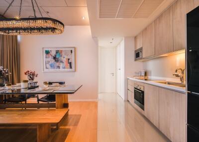 Elegant kitchen with adjoining dining area featuring modern appliances and artistic decor