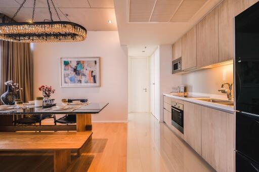 Elegant kitchen with adjoining dining area featuring modern appliances and artistic decor