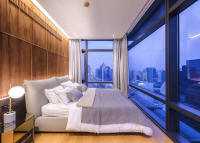 Modern bedroom with panoramic city view through large windows