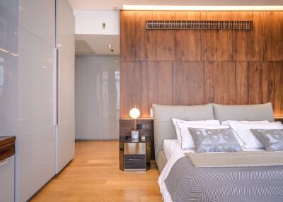 Modern bedroom with wooden wall paneling and ambient lighting