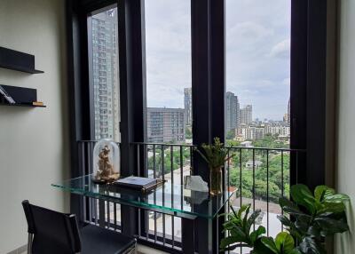 Modern room with glass desk near large windows overlooking the city