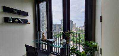 Modern room with glass desk near large windows overlooking the city