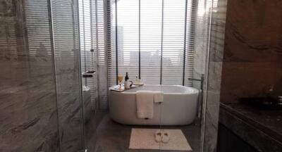 Modern bathroom with elegant bathtub and sophisticated stone tiling
