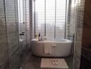 Modern bathroom with elegant bathtub and sophisticated stone tiling