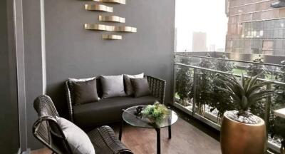 Cozy balcony with modern seating and lush plant decor