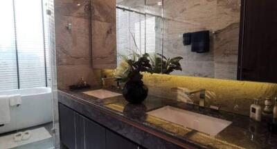 Modern bathroom interior with illuminated yellow marble countertop and double sinks