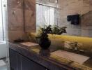 Modern bathroom interior with illuminated yellow marble countertop and double sinks