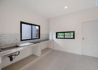 Modern kitchen with large windows and white brick backsplash