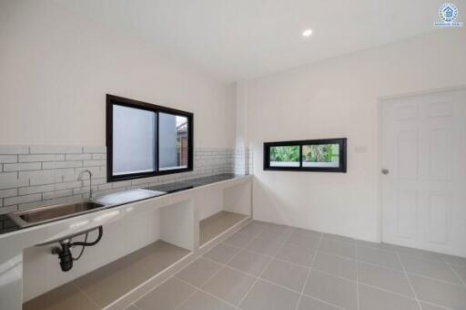 Modern kitchen with large windows and white brick backsplash