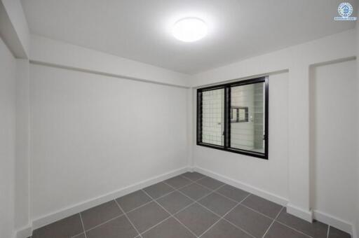 Spacious and well-lit empty bedroom with large window