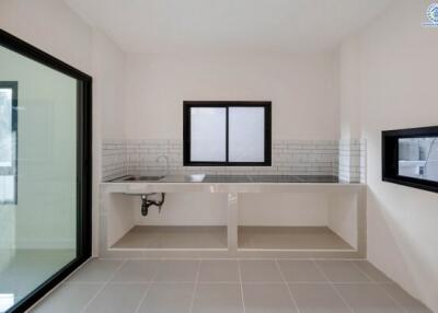 Modern minimalistic kitchen with white tiled backsplash and large windows