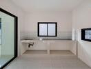Modern minimalistic kitchen with white tiled backsplash and large windows