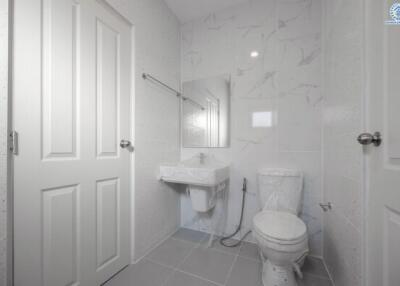 Modern white tiled bathroom with natural light
