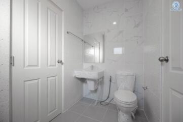 Modern white tiled bathroom with natural light