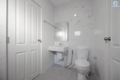 Modern white tiled bathroom with natural light