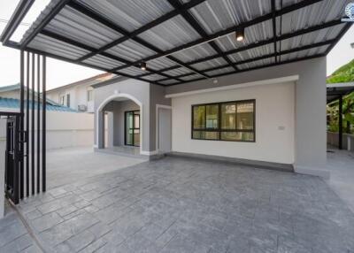 Modern carport with tiled floor and adjoining house