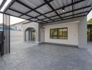 Modern carport with tiled floor and adjoining house