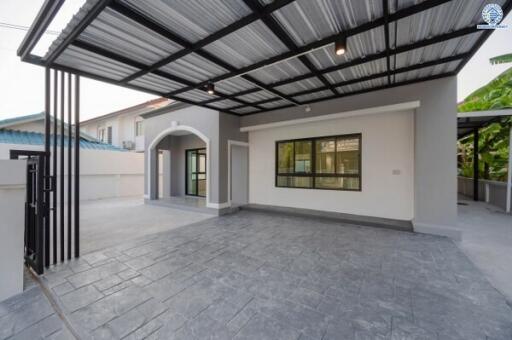 Modern carport with tiled floor and adjoining house
