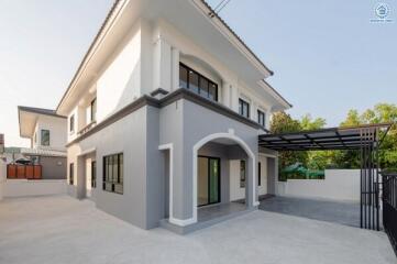 Modern two-story house with external carport