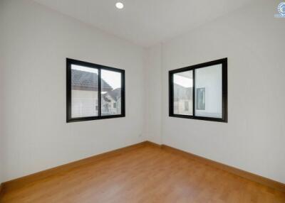 Spacious and bright empty bedroom with two windows