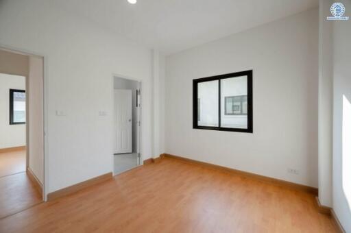 Spacious and well-lit empty bedroom with hardwood floors